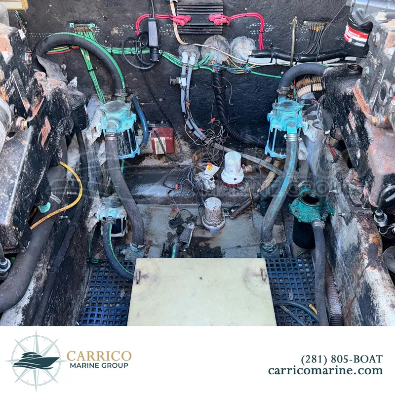 Slide: The Image of Engine compartment of a 1990 Sea Ray 390 Express Cruiser with visible wiring and components. - 35