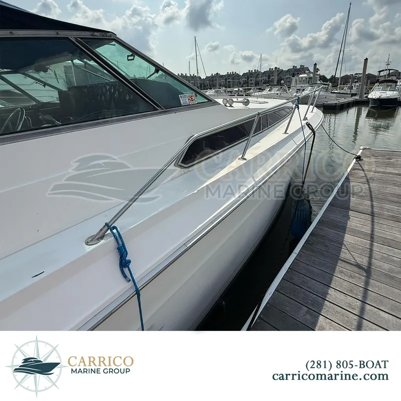 Slide: The Image of 1990 Sea Ray 390 Express Cruiser docked at marina, sunny day, Carrico Marine Group. - 4
