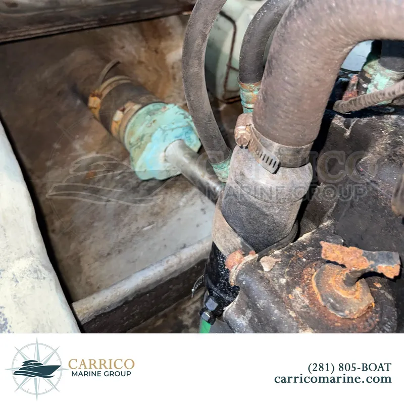 Slide: The Image of Close-up of 1990 Sea Ray 390 Express Cruiser engine components, showing hoses and rusted parts. - 44