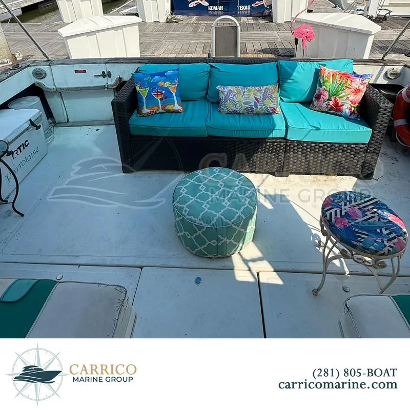 Slide: The Image of 1990 Sea Ray 390 Express Cruiser deck with colorful seating and cushions. - 8