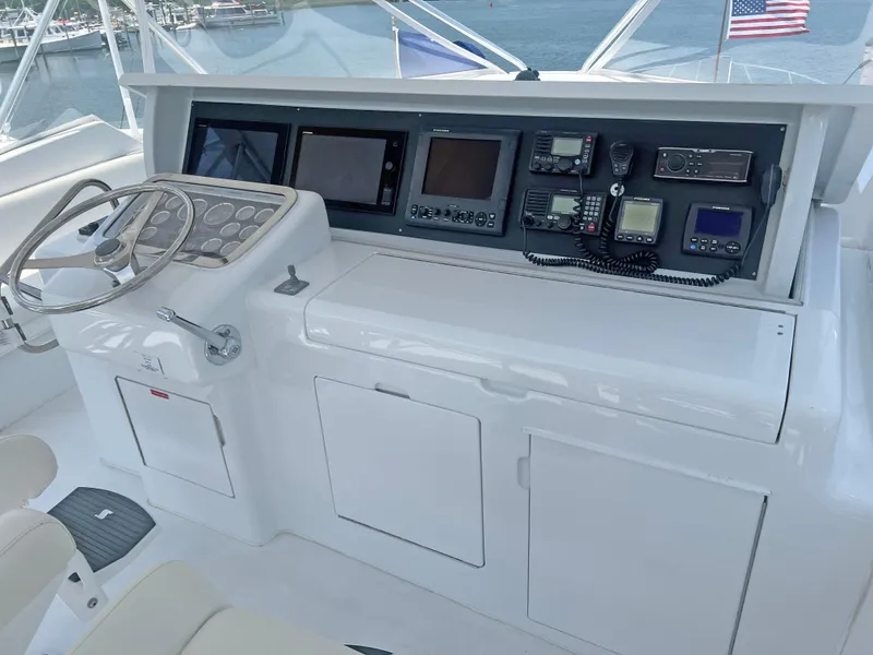 Slide: The Image of Helm of 2000 Hatteras 60 Convertible yacht with navigation equipment and steering wheel. - 11