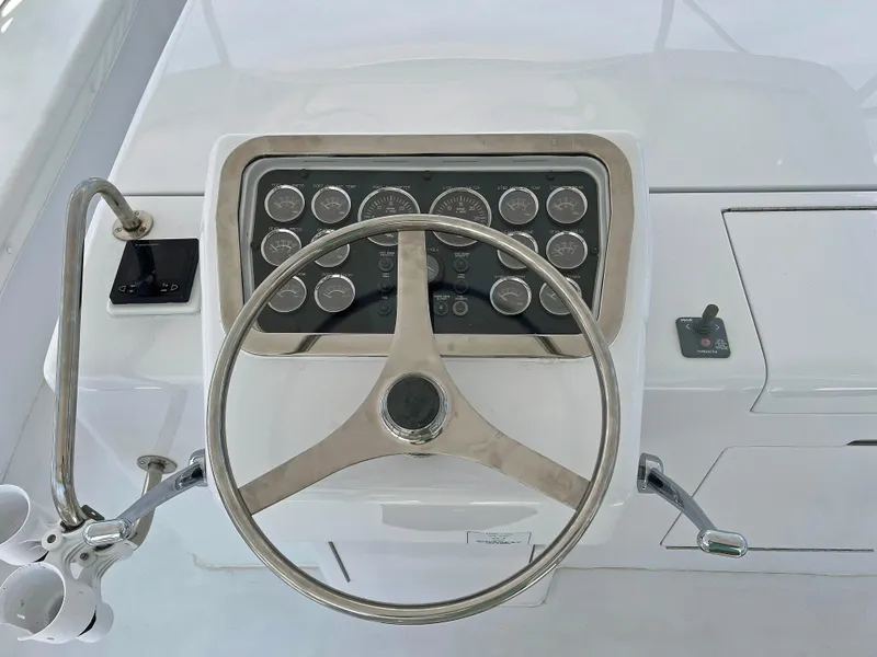 Slide: The Image of Steering wheel and dashboard of 2000 Hatteras 60 Convertible yacht. - 12