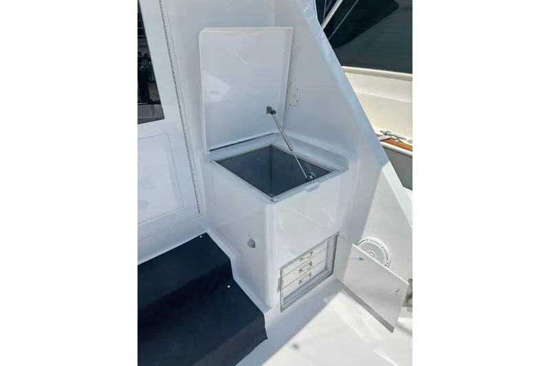 Slide: The Image of Hatteras 60 Convertible 2000 yacht interior with open storage compartment and drawers. - 14