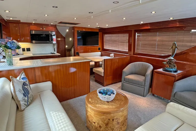 Slide: The Image of Luxurious interior of 2000 Hatteras 60 Convertible yacht with elegant wood finishes and cozy seating. - 17