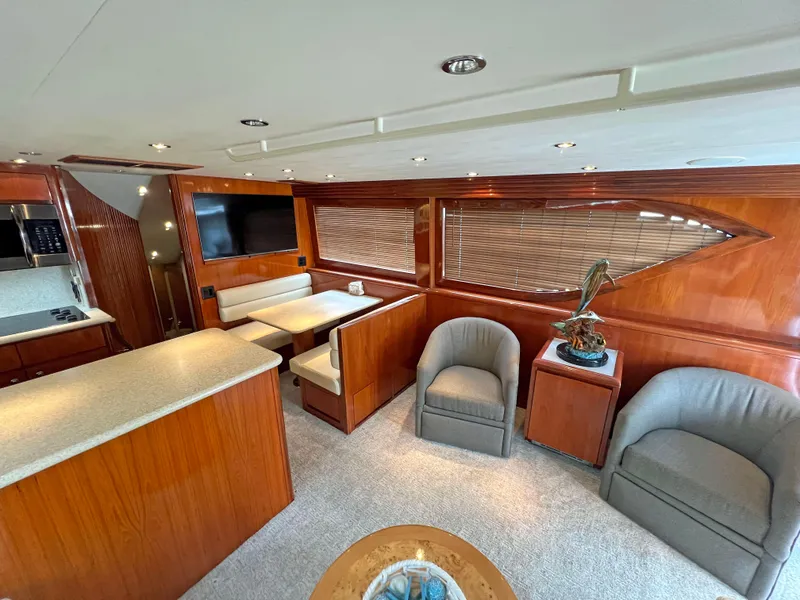 Slide: The Image of Luxurious interior of 2000 Hatteras 60 Convertible yacht with elegant wood finishes and modern amenities. - 18