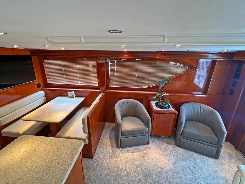 Slide: The Image of Luxurious interior of 2000 Hatteras 60 Convertible yacht with seating and dining area. - 19