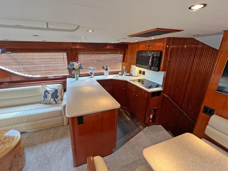 Slide: The Image of Luxurious interior of 2000 Hatteras 60 Convertible yacht with modern kitchen and seating area. - 20