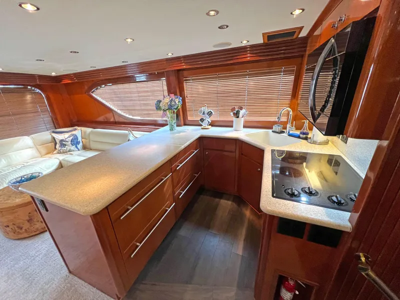 Slide: The Image of Luxurious kitchen interior of 2000 Hatteras 60 Convertible yacht with modern amenities. - 21
