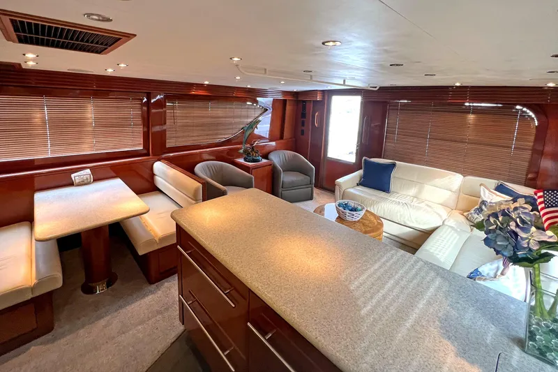 Slide: The Image of Luxurious interior of 2000 Hatteras 60 Convertible yacht with elegant seating and dining area. - 22