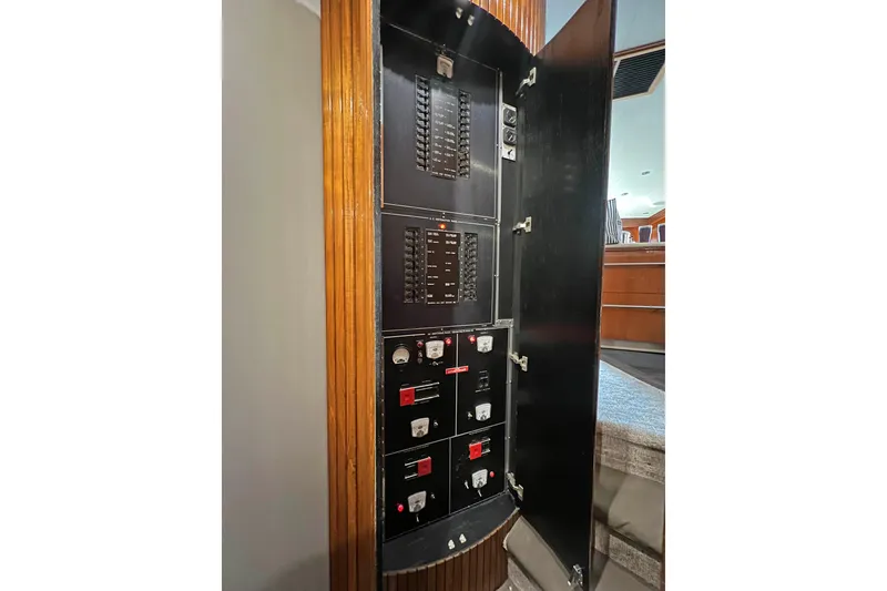 Slide: The Image of Electrical panel inside a 2000 Hatteras 60 Convertible yacht, showcasing circuit breakers and controls. - 25
