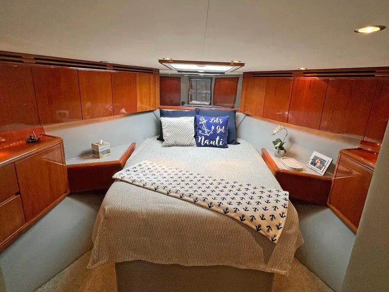 Slide: The Image of Luxurious cabin interior of 2000 Hatteras 60 Convertible yacht with cozy bedding. - 26