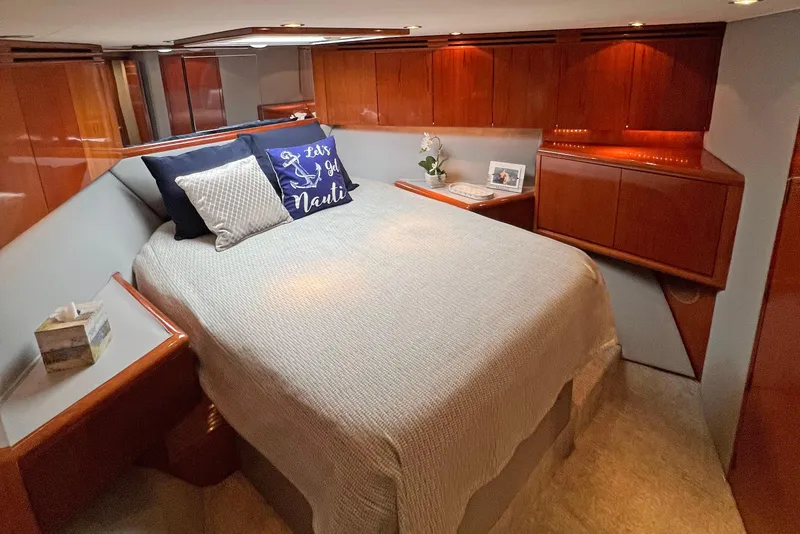 Slide: The Image of Luxurious bedroom interior of 2000 Hatteras 60 Convertible yacht with elegant wood finishes. - 27