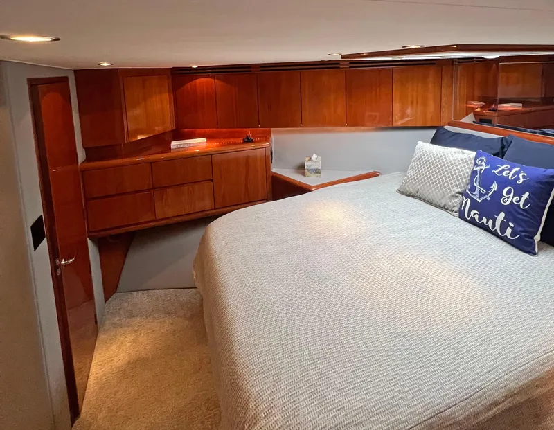 Slide: The Image of Luxurious bedroom interior of 2000 Hatteras 60 Convertible yacht with wooden cabinetry. - 28