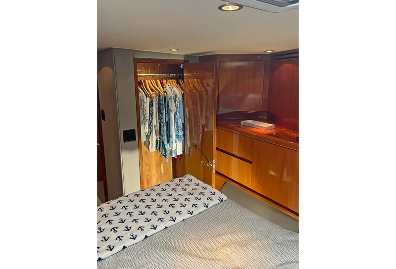 Slide: The Image of Luxurious cabin interior of 2000 Hatteras 60 Convertible yacht with wooden closet and bed. - 29