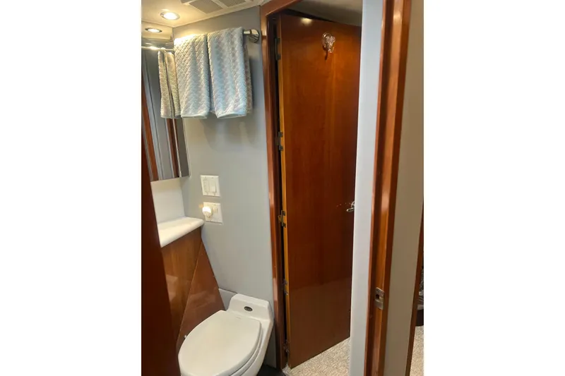 Slide: The Image of Bathroom interior of 2000 Hatteras 60 Convertible yacht, featuring wooden door and modern fixtures. - 31