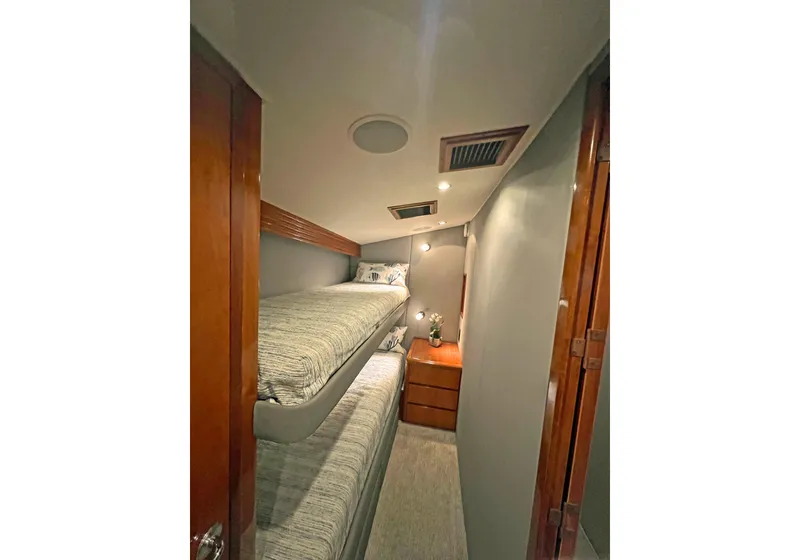 Slide: The Image of Interior of 2000 Hatteras 60 Convertible yacht with bunk beds and wooden cabinetry. - 34