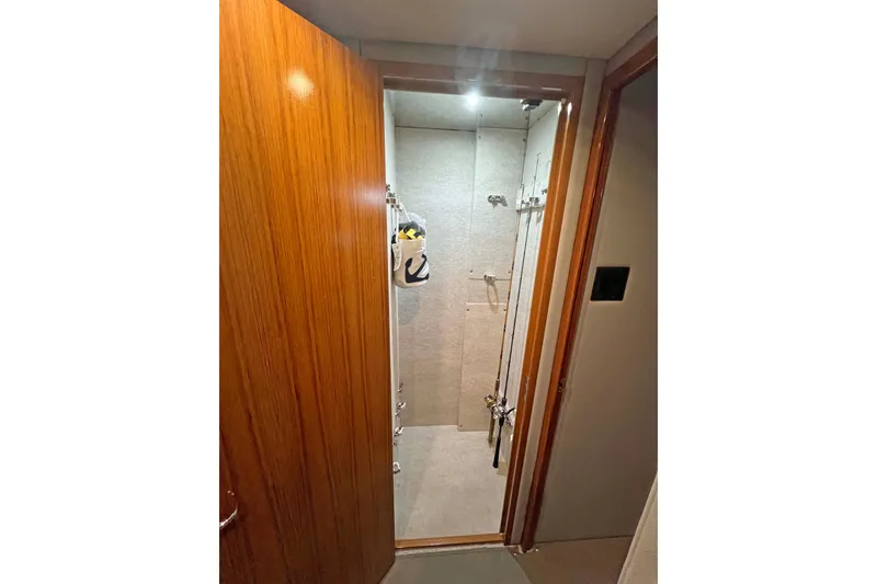 Slide: The Image of Interior view of 2000 Hatteras 60 Convertible yacht, featuring a compact storage area. - 36