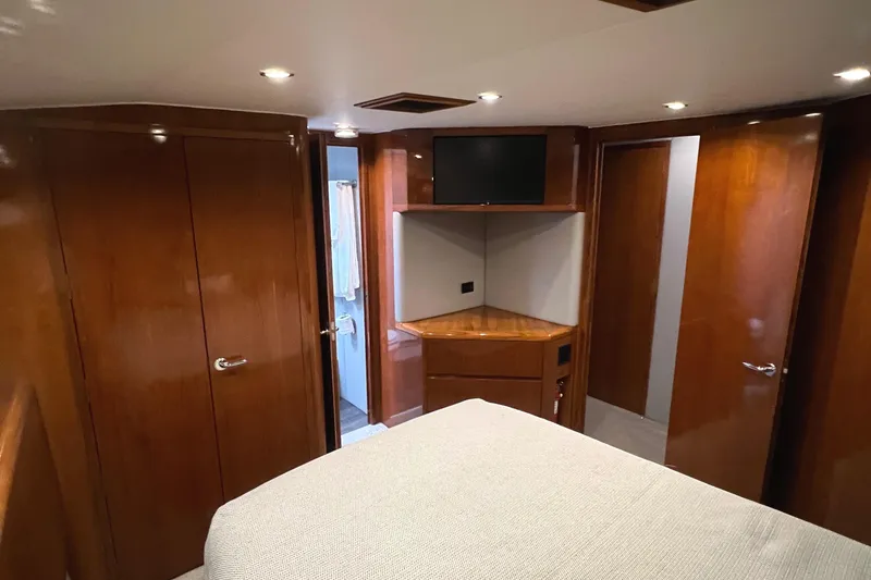 Slide: The Image of Luxurious cabin interior of 2000 Hatteras 60 Convertible yacht with wood paneling and modern amenities. - 38