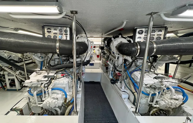Slide: The Image of Engine room of 2000 Hatteras 60 Convertible yacht, featuring dual engines and control panels. - 40