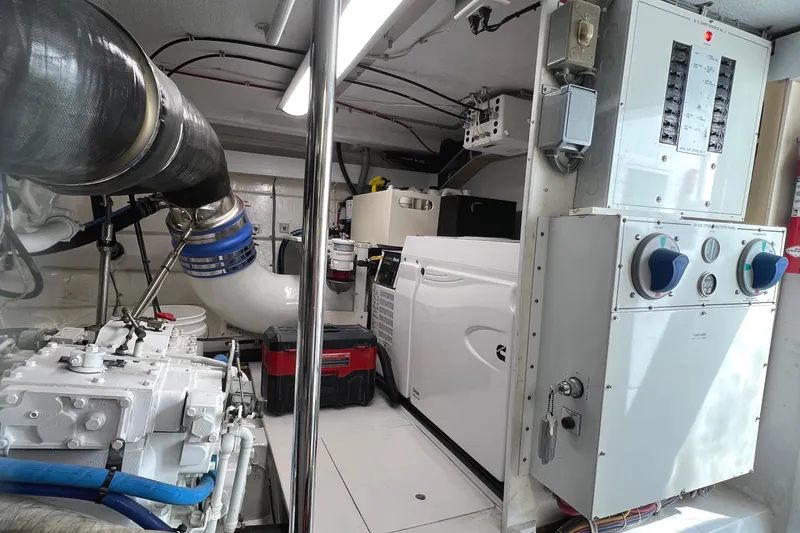 Slide: The Image of Engine room of 2000 Hatteras 60 Convertible yacht, featuring machinery and control panels. - 41