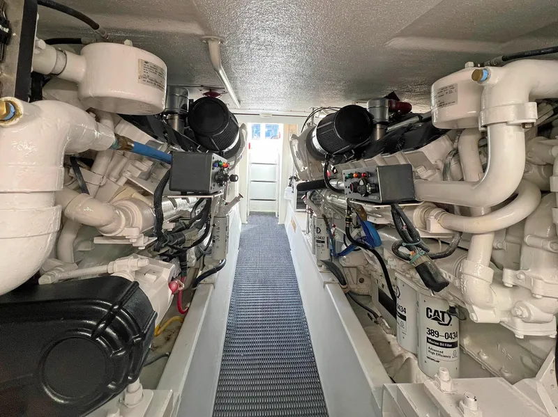 Slide: The Image of Engine room of a 2000 Hatteras 60 Convertible yacht, showcasing dual engines and components. - 45