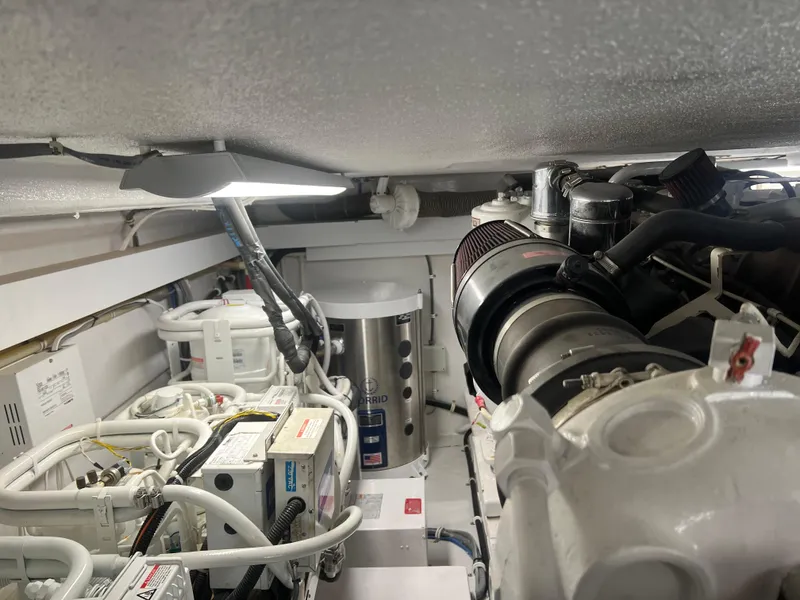 Slide: The Image of Engine room of 2000 Hatteras 60 Convertible yacht, showcasing machinery and components. - 46
