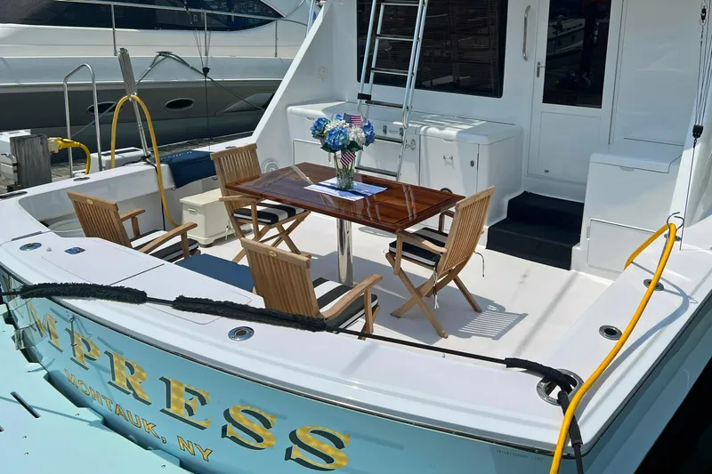 Slide: The Image of Hatteras 60 Convertible 2000 yacht deck with dining table and chairs, Montauk, NY. - 6
