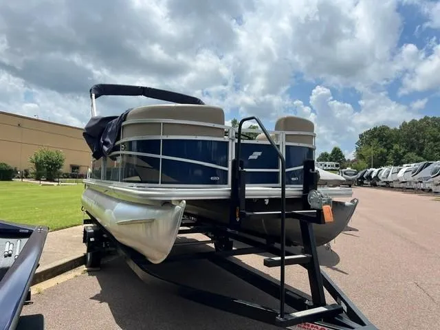 Slide: The Image of 2023 Starcraft LX18 R pontoon boat on trailer under cloudy sky. - 3