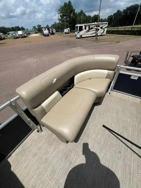 Slide: The Image of 2023 Starcraft LX18 R boat with beige seating, parked in a lot with RVs in the background. - 4