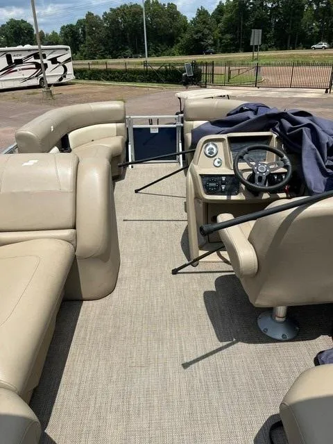 Slide: The Image of 2023 Starcraft LX18 R boat interior with beige seating and steering console. - 5