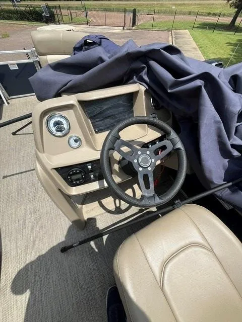 Slide: The Image of 2023 Starcraft LX18 R boat dashboard with steering wheel and controls. - 6