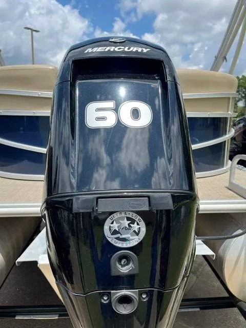 Slide: The Image of 2023 Starcraft LX18 R with Mercury 60 outboard motor, under a partly cloudy sky. - 9