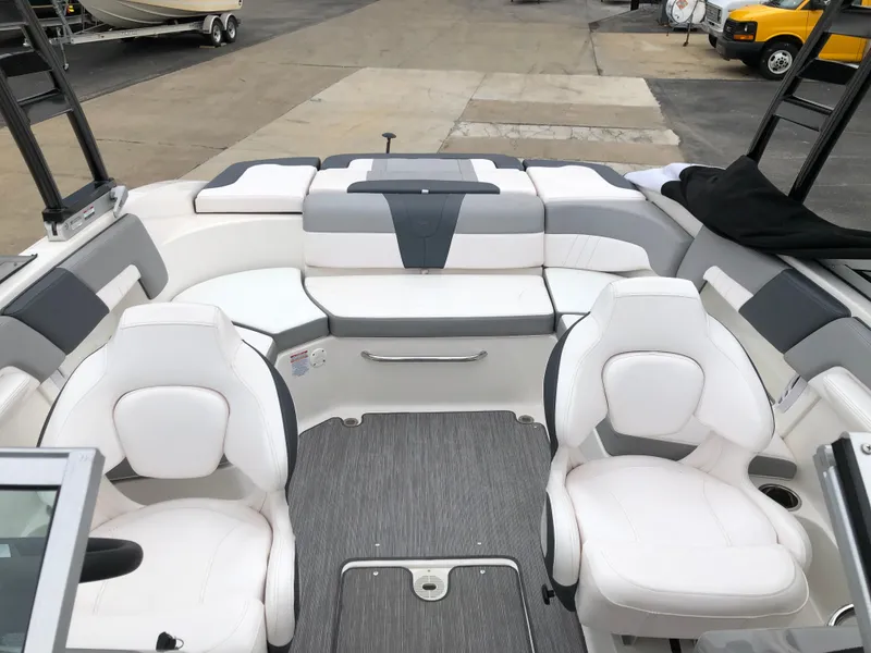 Slide: The Image of 2021 Chaparral 23 SSi boat interior with white seating and modern design. - 10