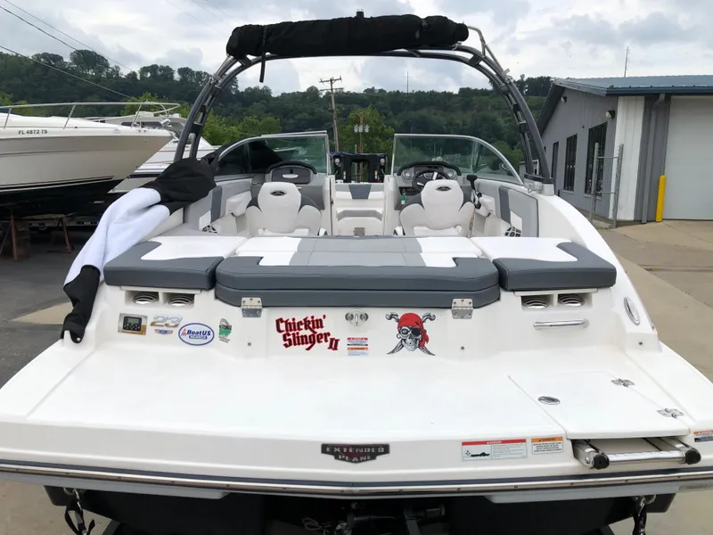 Slide: The Image of 2021 Chaparral 23 SSi boat with custom graphics, docked at a marina. - 4