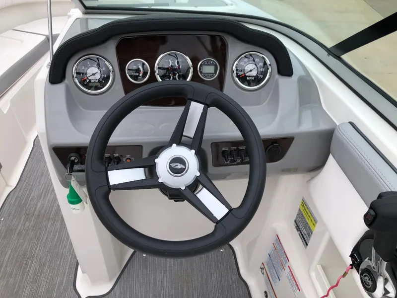 Slide: The Image of 2021 Chaparral 23 SSi boat dashboard with steering wheel and gauges. - 8