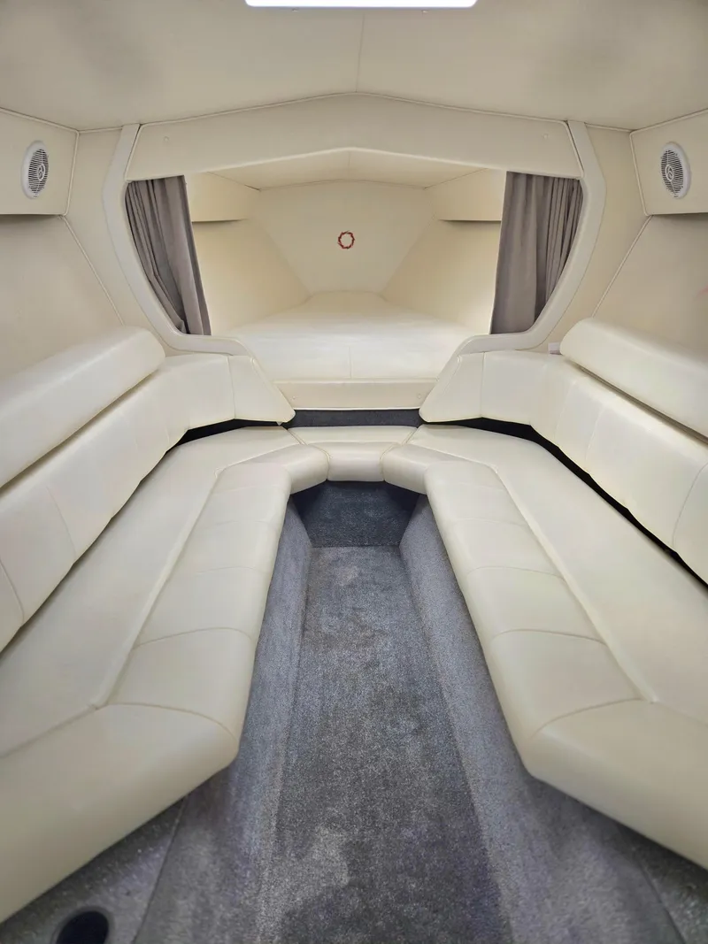 Slide: The Image of Interior of a 2004 Fountain 47 Lightning boat with beige seating and carpeted floor. - 10