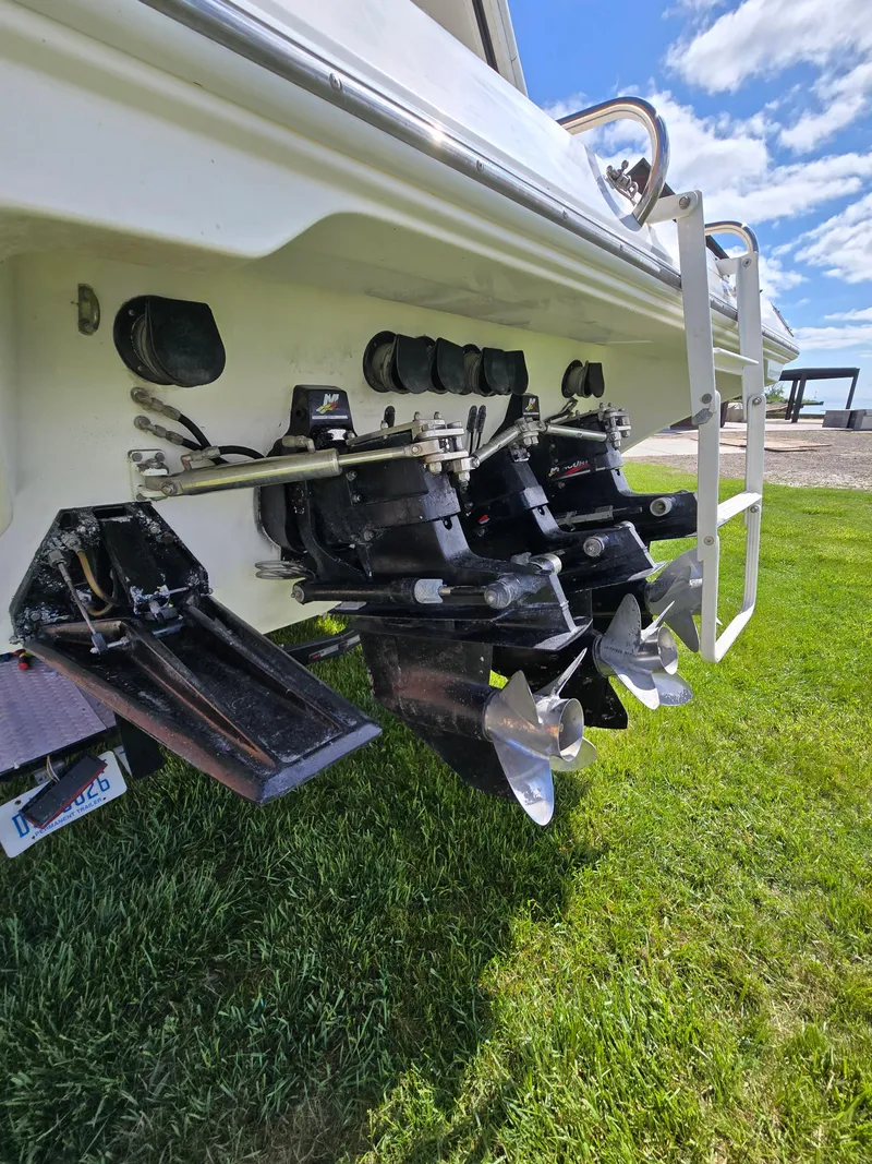 Slide: The Image of 2004 Fountain 47 Lightning boat stern with dual propellers on grass. - 4