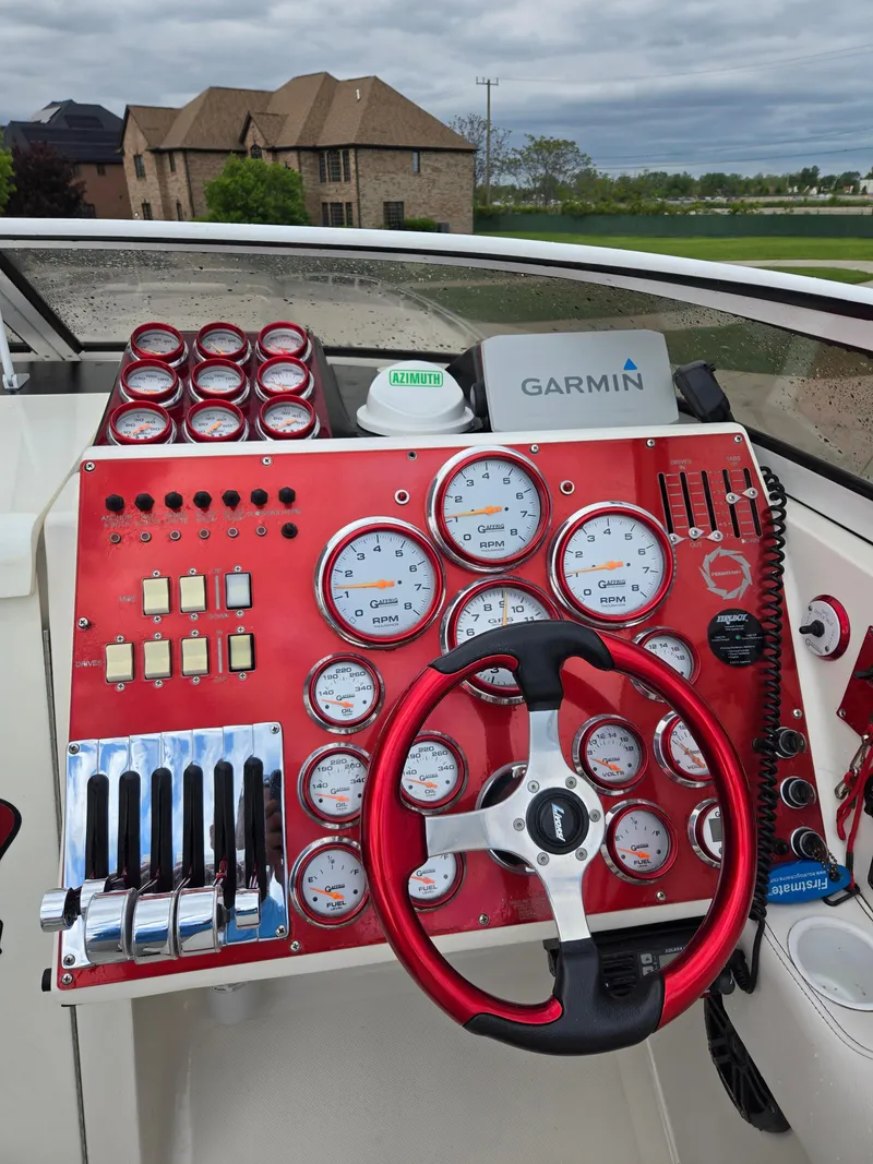 Slide: The Image of Control panel of a 2004 Fountain 47 Lightning boat with gauges and Garmin navigation. - 5
