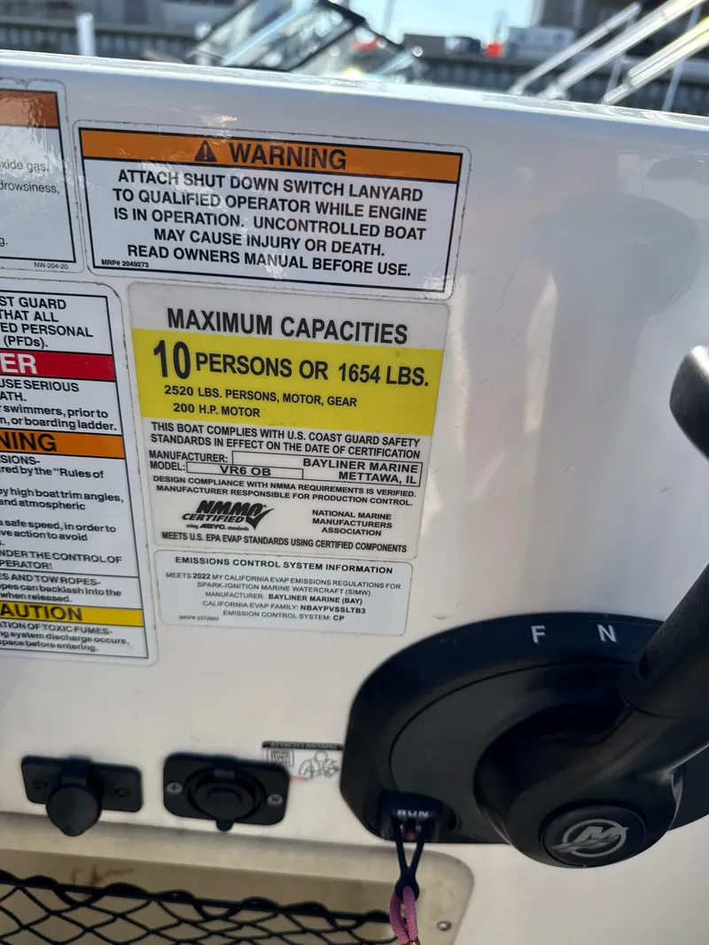 Slide: The Image of 2022 Bayliner VR6 Bowrider OB capacity warning label, maximum 10 persons or 1654 lbs. - 10