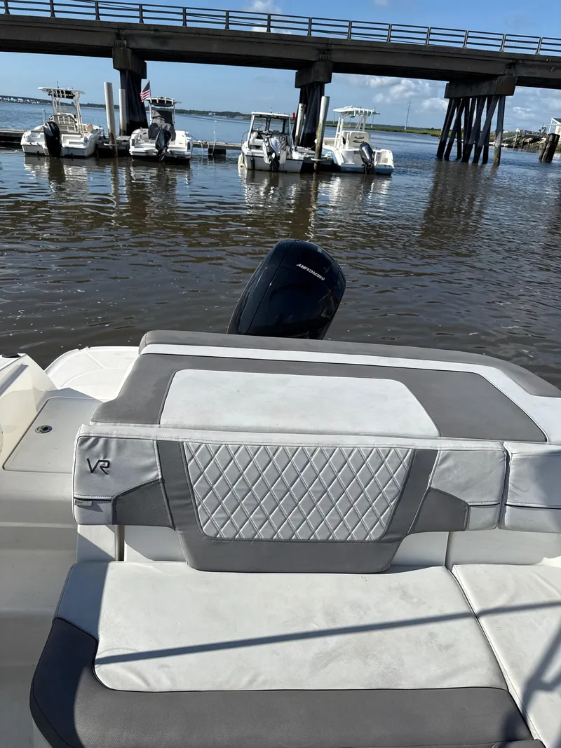 Slide: The Image of 2022 Bayliner VR6 Bowrider OB at dock, featuring stylish seating and outboard motor. - 6