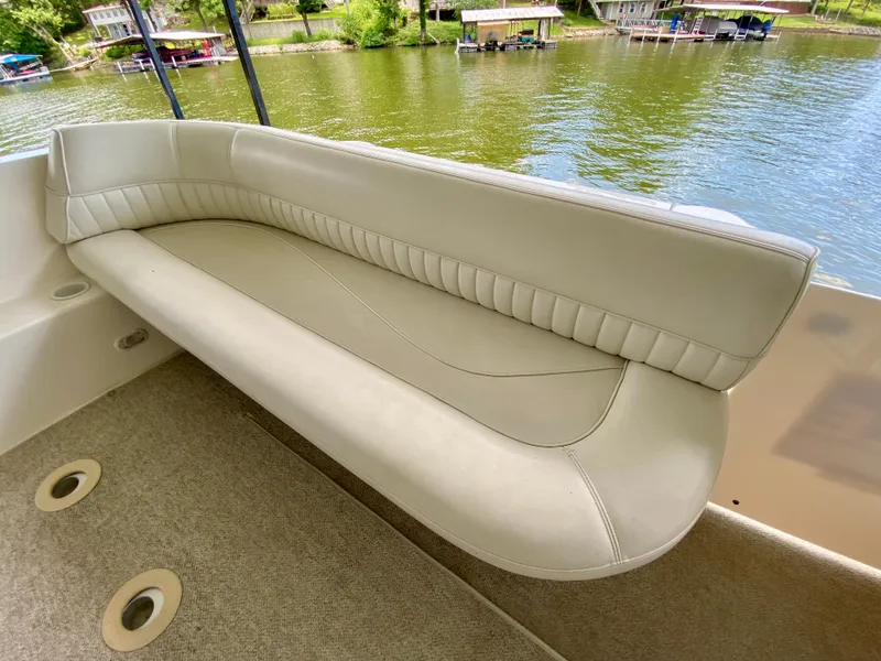 Slide: The Image of 1999 Cruisers Yachts 3375 Esprit interior with beige seating, overlooking a serene lake. - 10