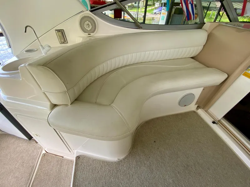 Slide: The Image of 1999 Cruisers Yachts 3375 Esprit interior with white leather seating and speaker. - 11