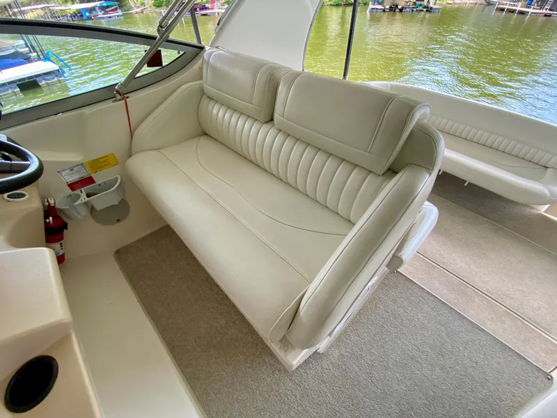 Slide: The Image of 1999 Cruisers Yachts 3375 Esprit interior with beige seating and lake view. - 12