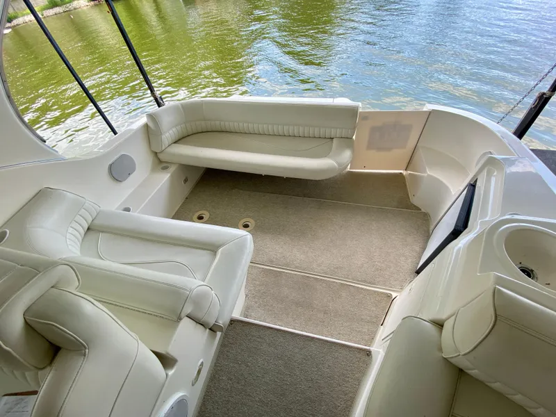 Slide: The Image of 1999 Cruisers Yachts 3375 Esprit interior with white seating and lake view. - 15