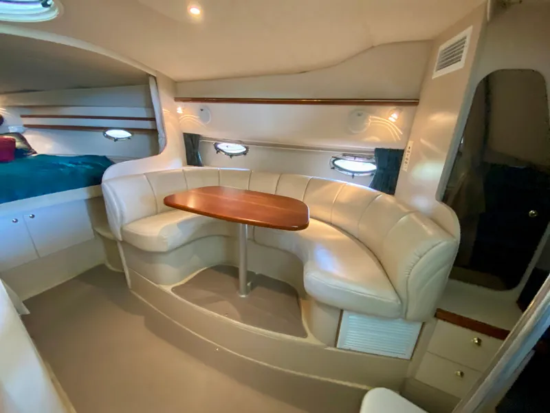 Slide: The Image of Interior of 1999 Cruisers Yachts 3375 Esprit with cozy seating and wooden table. - 20