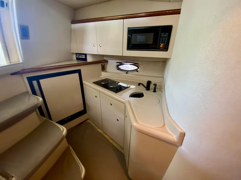 Slide: The Image of 1999 Cruisers Yachts 3375 Esprit galley with microwave, stove, and sink. - 22