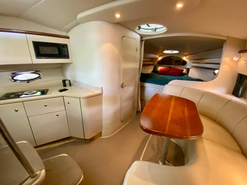 Slide: The Image of 1999 Cruisers Yachts 3375 Esprit interior with kitchen, dining area, and cozy sleeping quarters. - 23