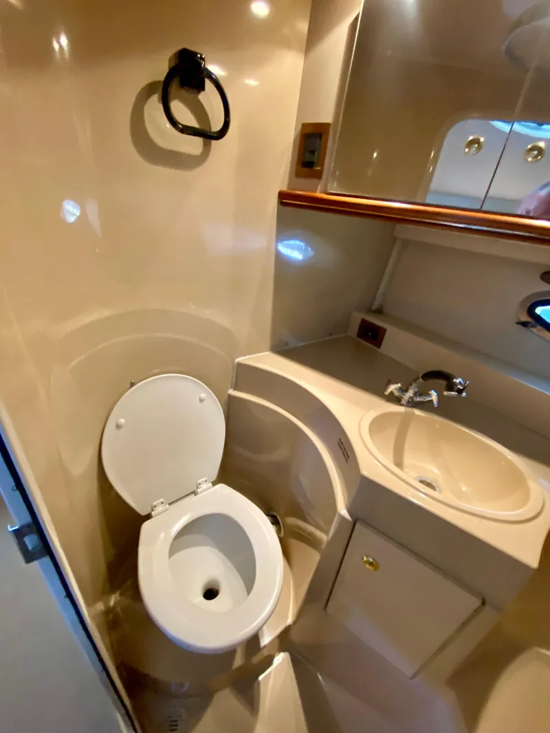 Slide: The Image of 1999 Cruisers Yachts 3375 Esprit bathroom with toilet, sink, and mirror. - 30