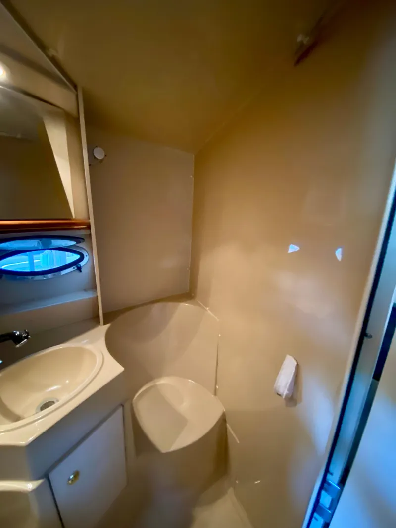 Slide: The Image of 1999 Cruisers Yachts 3375 Esprit bathroom with sink, mirror, and porthole window. - 31