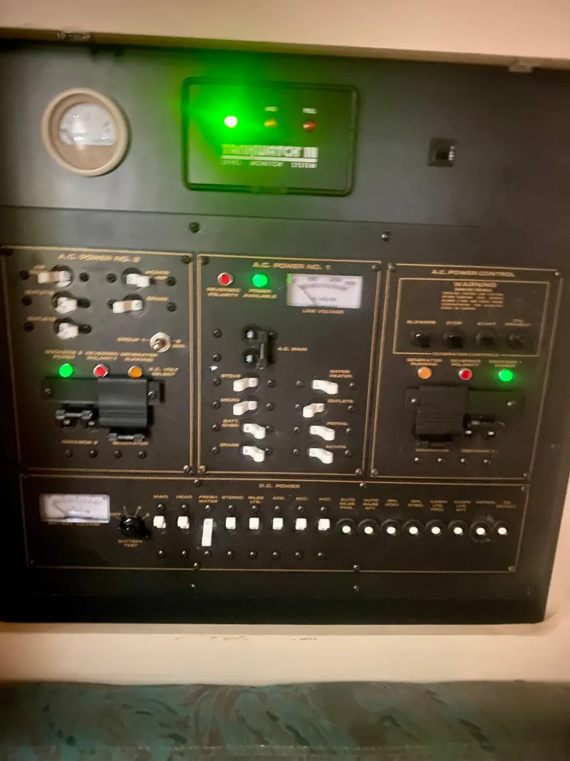 Slide: The Image of Control panel of a 1999 Cruisers Yachts 3375 Esprit with illuminated switches and gauges. - 38